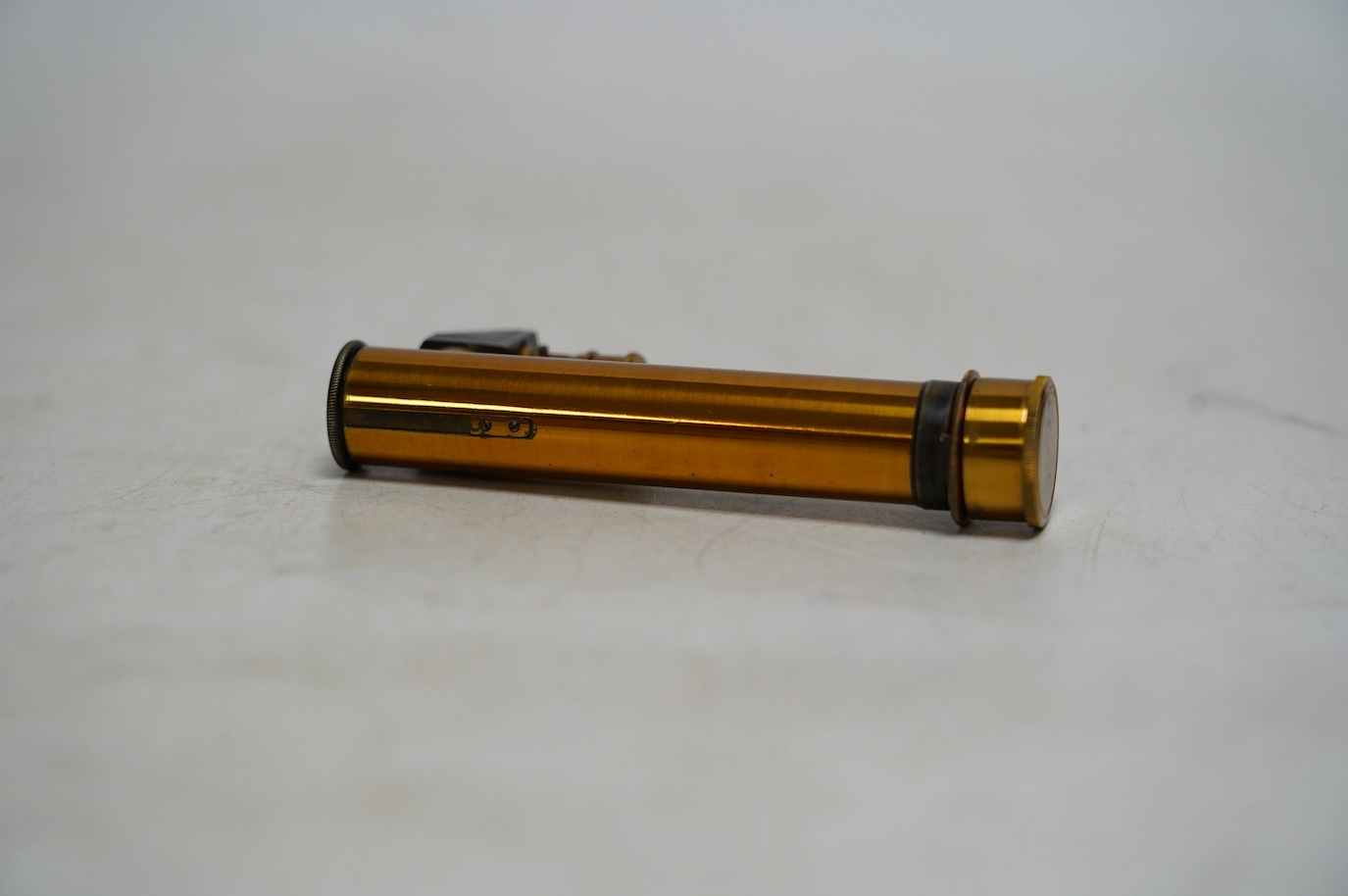 A late 19th century cased brass pocket spectroscope, engraved ‘John Browning London’ 8.5cm. Condition - fair